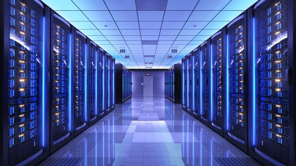 Modern data centre server room with illuminated server racks